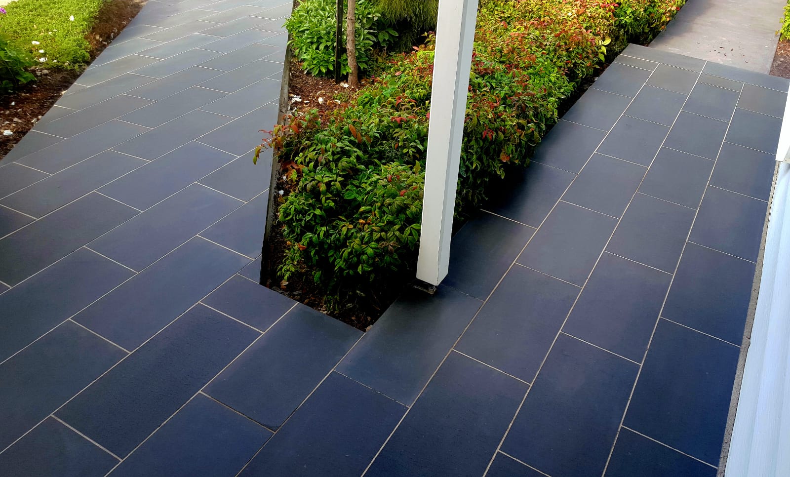 Bluestone paving winding through an established garden